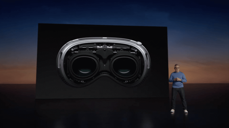 Apple Vision Pro is on stage, shown on a large screen behind it.